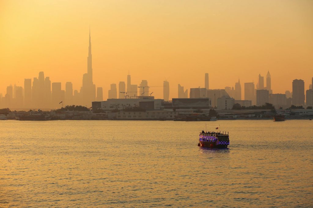 vessel sailing on dubai coast at sunset