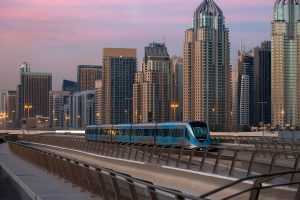dubai metro at sunset with iconic skyline